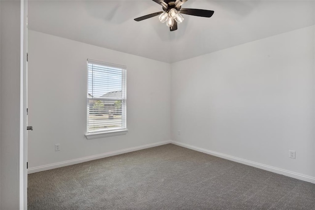 carpeted spare room featuring ceiling fan