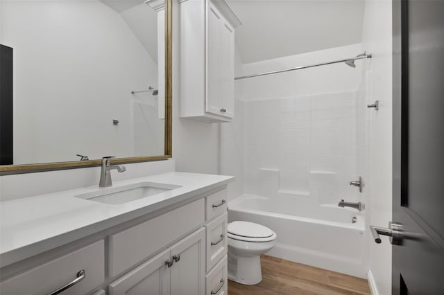 full bathroom featuring toilet, vanity, tub / shower combination, and hardwood / wood-style flooring