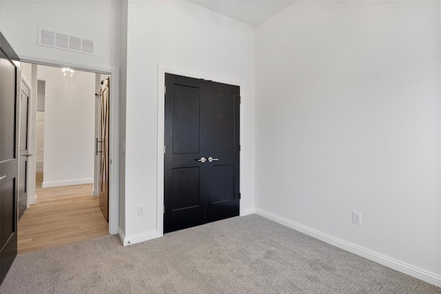 unfurnished bedroom with light carpet