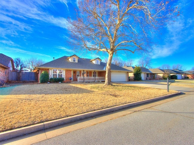 ranch-style home featuring a garage, a front lawn, and a porch