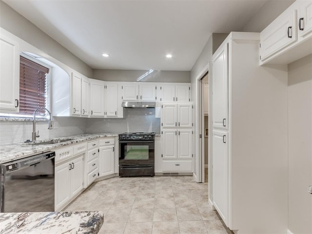 kitchen with sink, light stone counters, white cabinetry, decorative backsplash, and black appliances