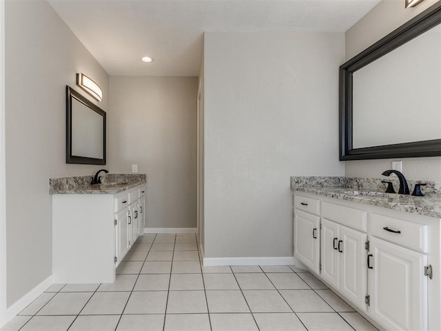 bathroom featuring tile patterned flooring and vanity