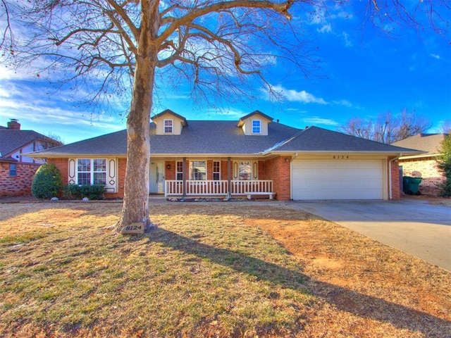 view of front of property featuring a garage, covered porch, and a front lawn