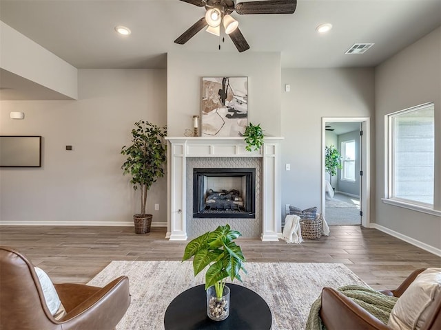 living room featuring light wood-type flooring and ceiling fan