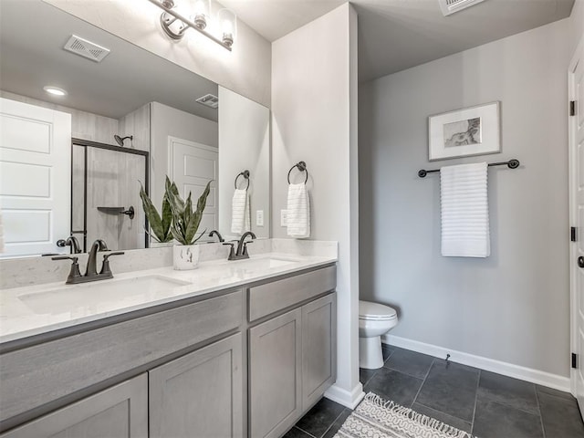 bathroom featuring tile patterned flooring, vanity, an enclosed shower, and toilet