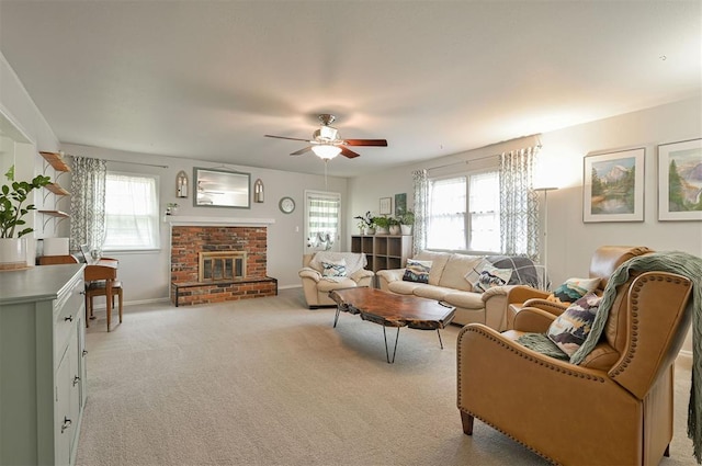 living room featuring ceiling fan, a fireplace, and light carpet