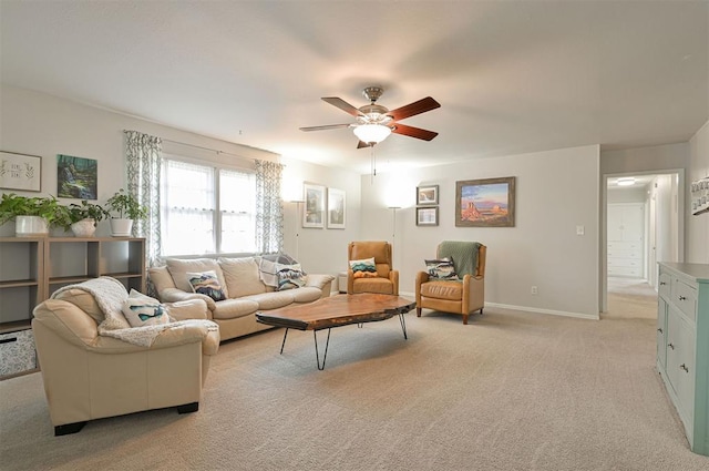 carpeted living room with ceiling fan