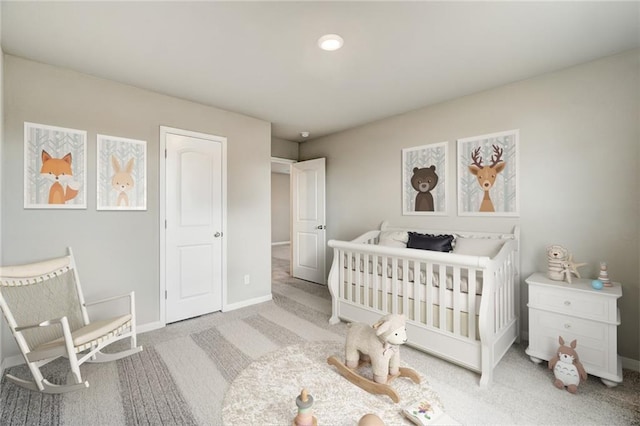 bedroom with light carpet and a crib