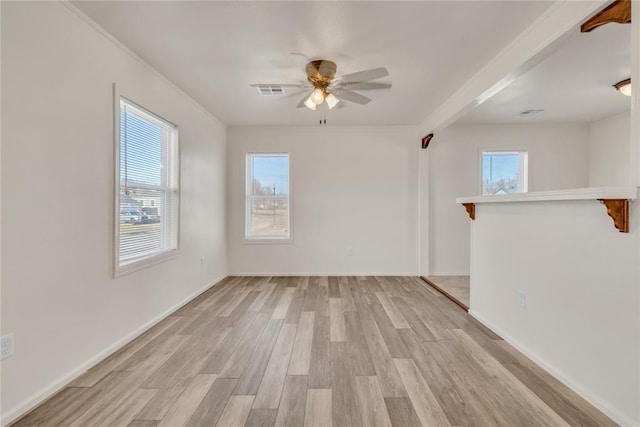 empty room featuring ceiling fan and light hardwood / wood-style flooring