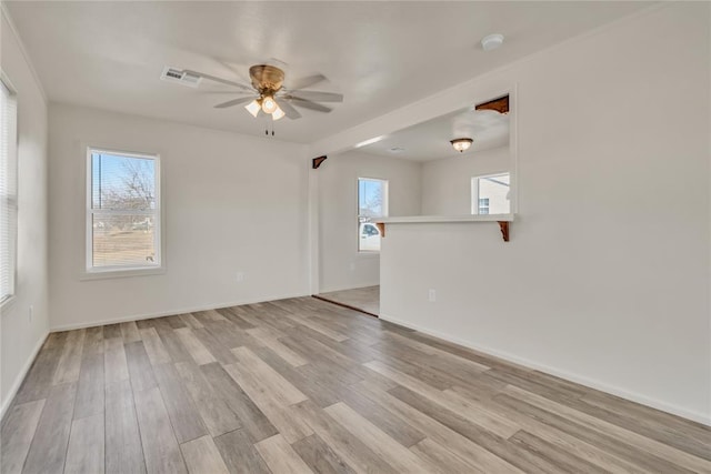 empty room featuring ceiling fan and light hardwood / wood-style flooring