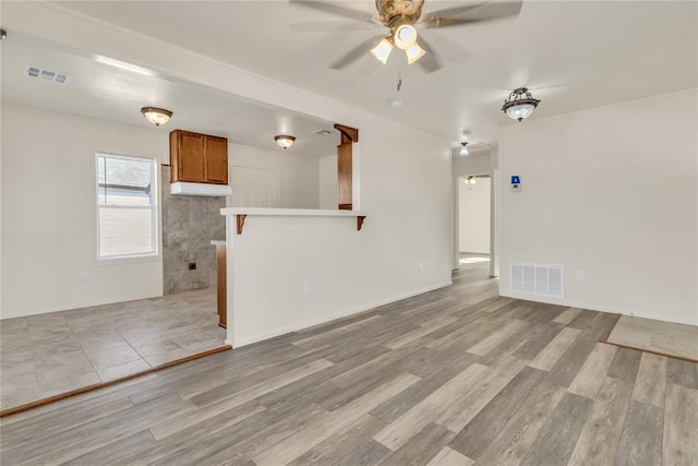 unfurnished living room with light hardwood / wood-style floors and ceiling fan