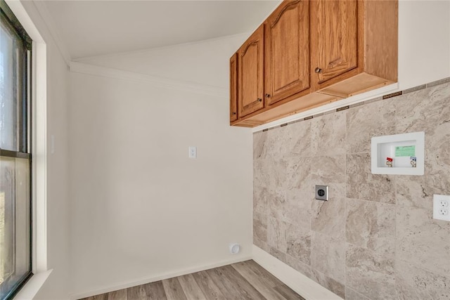 laundry room featuring electric dryer hookup, cabinets, crown molding, hookup for a washing machine, and light wood-type flooring