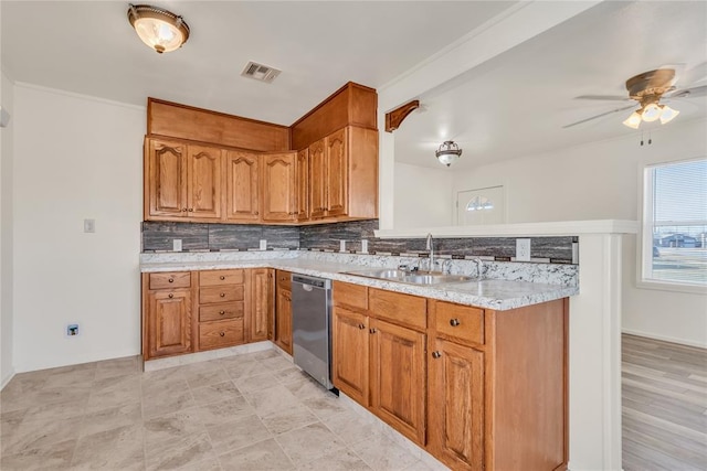 kitchen featuring dishwasher, sink, ceiling fan, decorative backsplash, and light stone counters