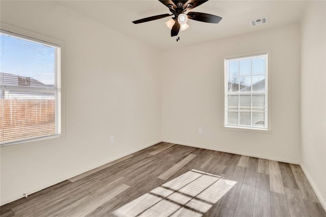 empty room featuring ceiling fan and light hardwood / wood-style floors