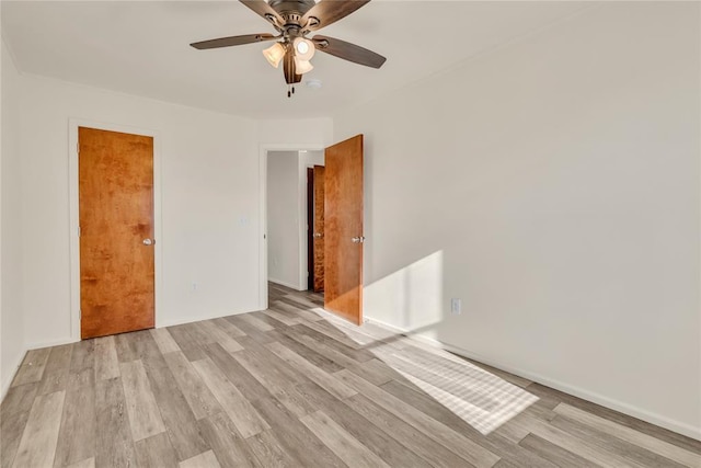 spare room with ceiling fan and light hardwood / wood-style flooring