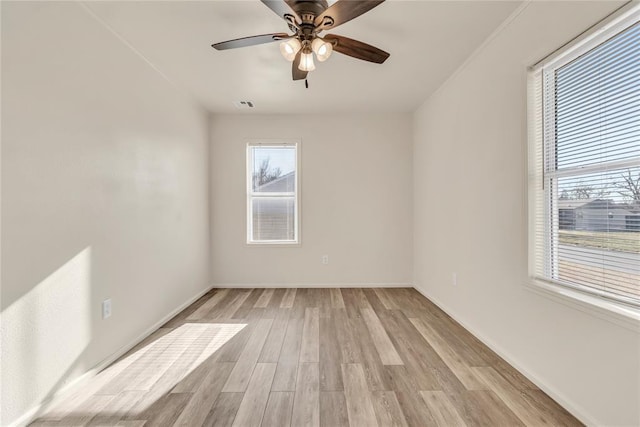 empty room featuring ceiling fan and light wood-type flooring