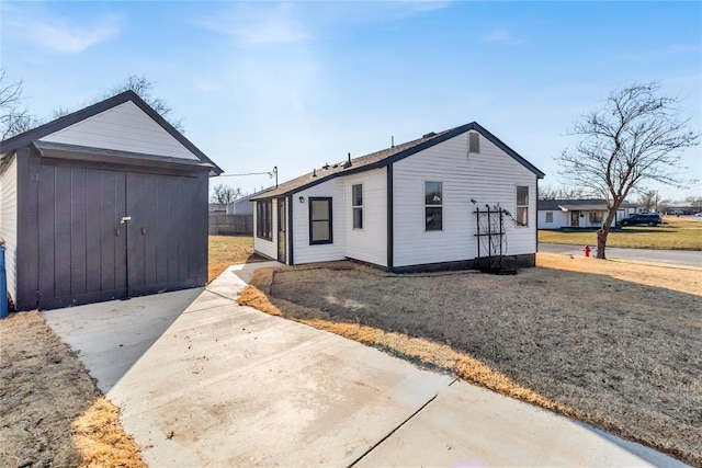 exterior space featuring a lawn and a storage unit