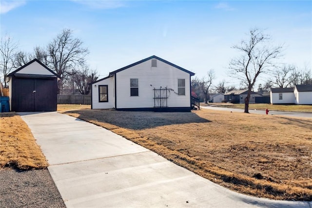 view of front of home featuring a storage shed