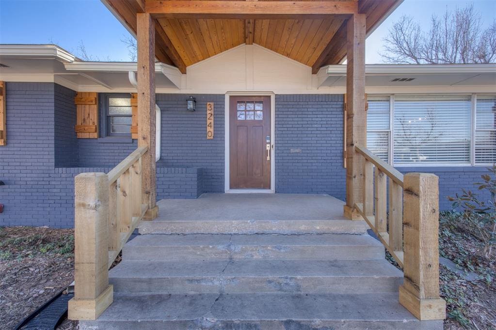 view of exterior entry with covered porch