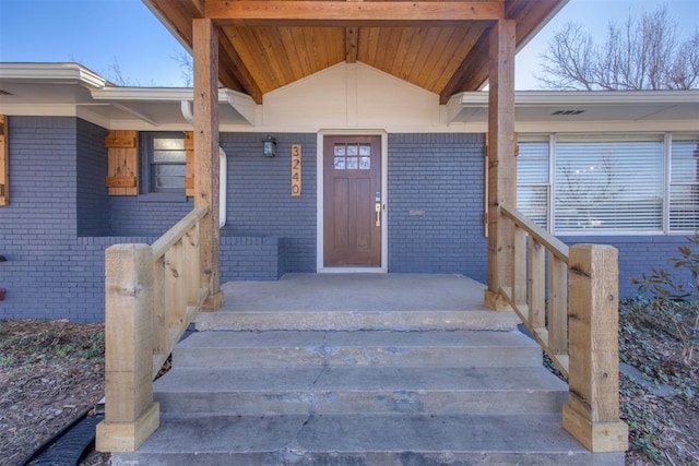 view of exterior entry with covered porch