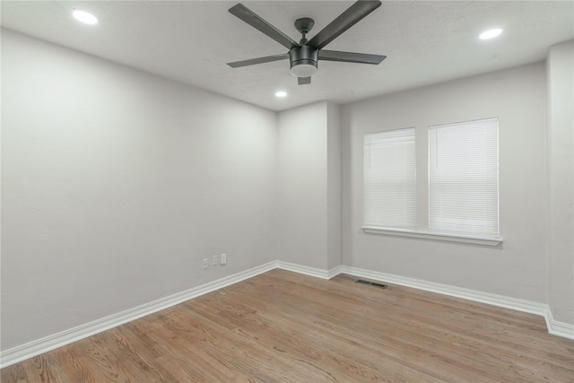 empty room featuring ceiling fan and light hardwood / wood-style floors