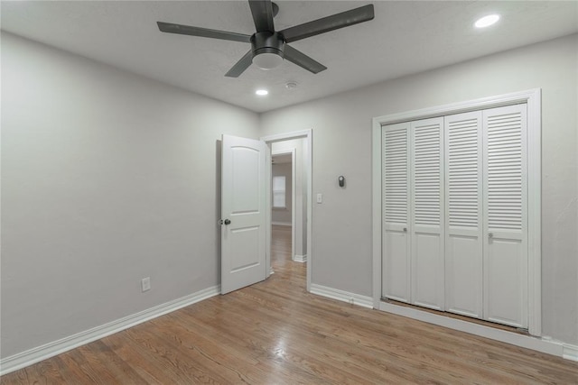 unfurnished bedroom with a closet, ceiling fan, and light wood-type flooring