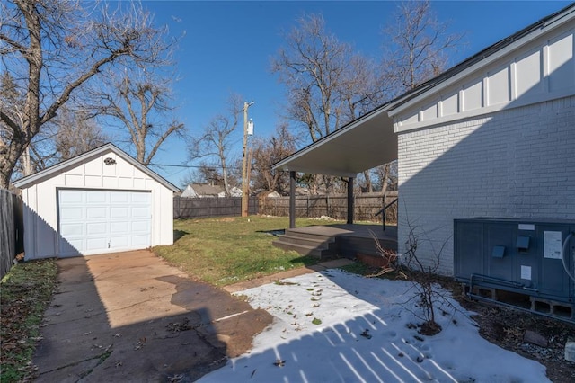 view of yard featuring a garage, an outbuilding, and a patio