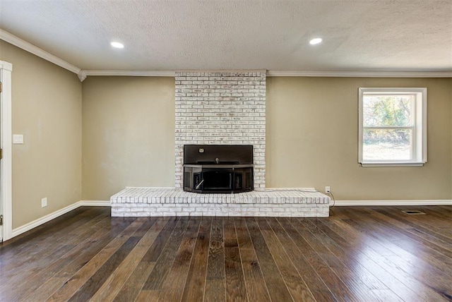 unfurnished living room featuring dark hardwood / wood-style flooring, a textured ceiling, and ornamental molding