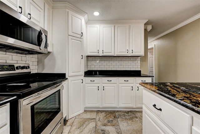 kitchen featuring tasteful backsplash, white cabinetry, ornamental molding, and appliances with stainless steel finishes