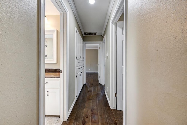 hallway with crown molding and dark hardwood / wood-style flooring