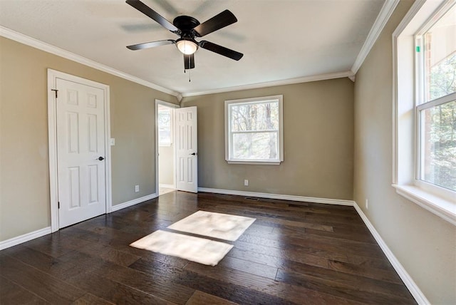 empty room featuring crown molding, dark hardwood / wood-style flooring, and ceiling fan