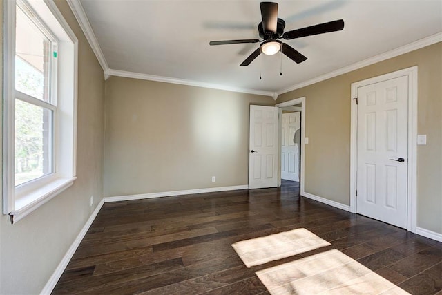 unfurnished bedroom with ceiling fan, ornamental molding, and dark wood-type flooring