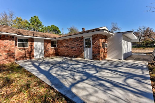 back of property with a patio