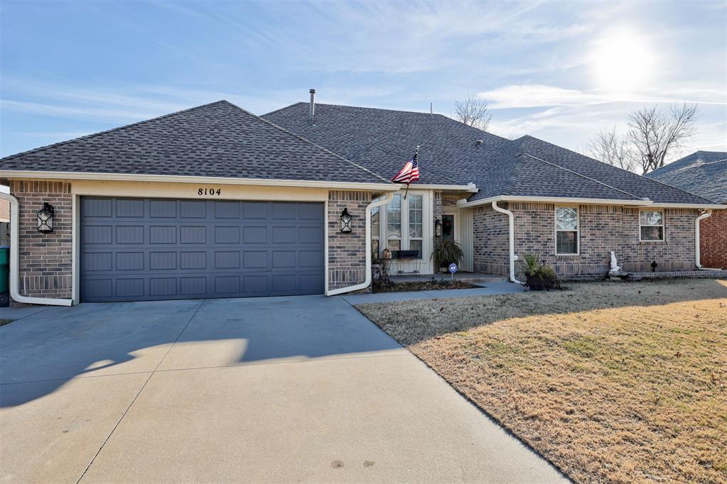 single story home with a front yard and a garage