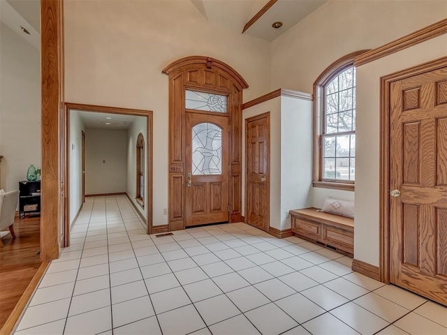 tiled entrance foyer featuring a high ceiling