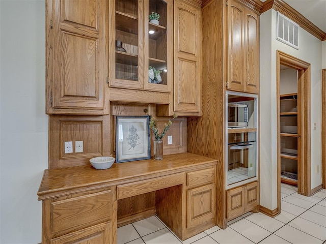 kitchen with appliances with stainless steel finishes and light tile patterned floors