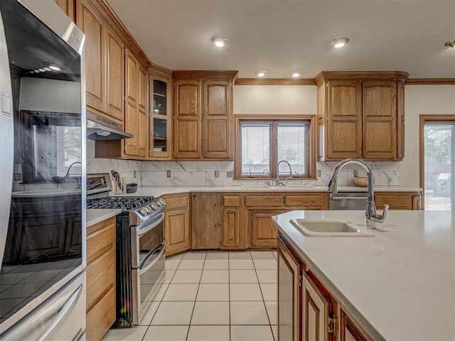 kitchen with light tile patterned floors, sink, refrigerator, double oven range, and ornamental molding