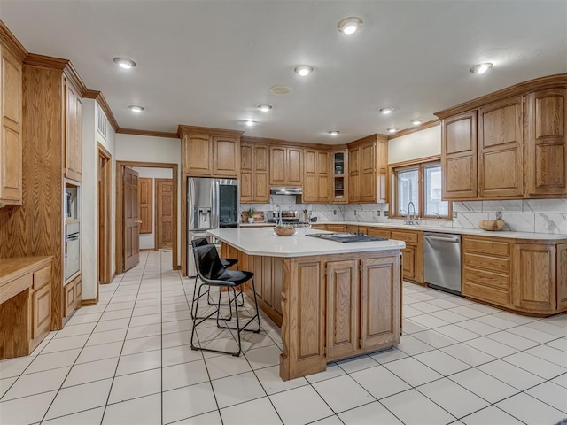 kitchen featuring backsplash, a kitchen breakfast bar, stainless steel appliances, and a center island