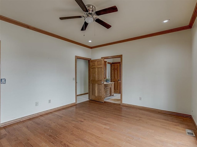 unfurnished room featuring crown molding, ceiling fan, and light wood-type flooring