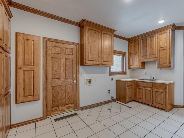 kitchen with light tile patterned flooring, ornamental molding, and sink