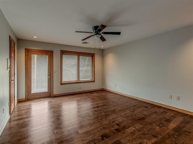 unfurnished room featuring ceiling fan and dark hardwood / wood-style flooring