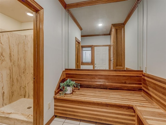 interior space featuring tile patterned flooring, ornamental molding, and walk in shower