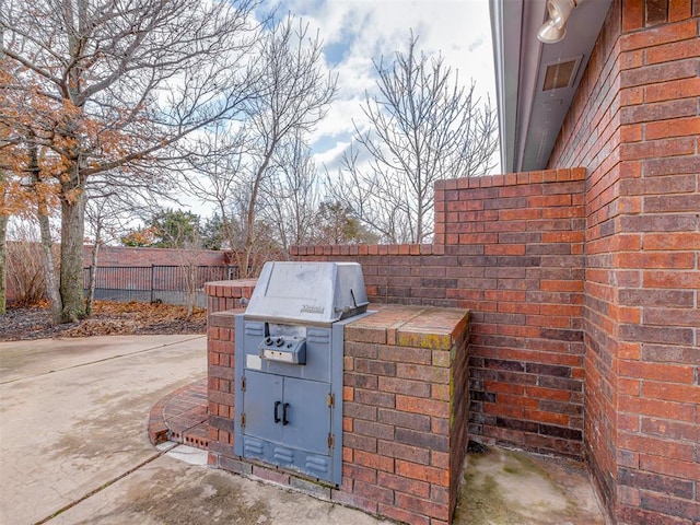 view of patio featuring a grill and an outdoor kitchen