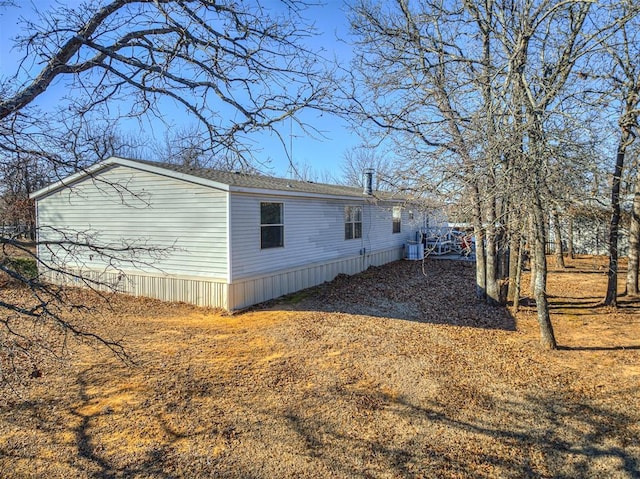 view of side of property featuring central AC