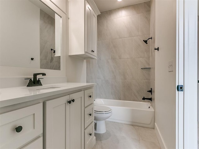 bathroom featuring toilet, shower / bath combination, vanity, baseboards, and tile patterned floors