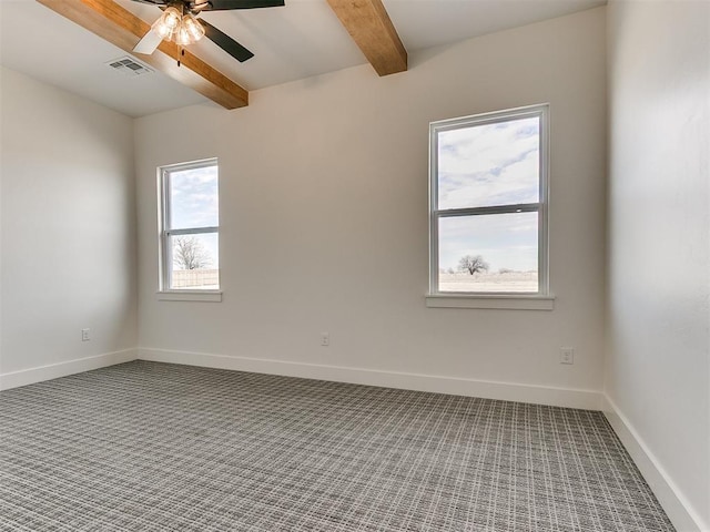 carpeted spare room with visible vents, beamed ceiling, baseboards, and ceiling fan