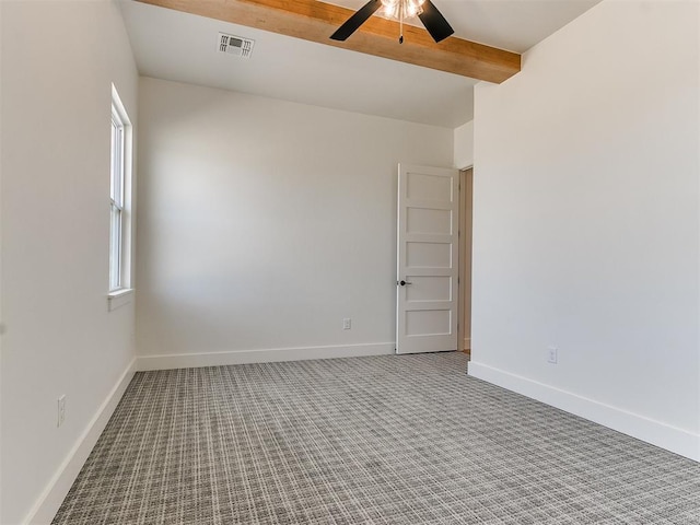 empty room featuring baseboards, visible vents, ceiling fan, carpet floors, and beam ceiling