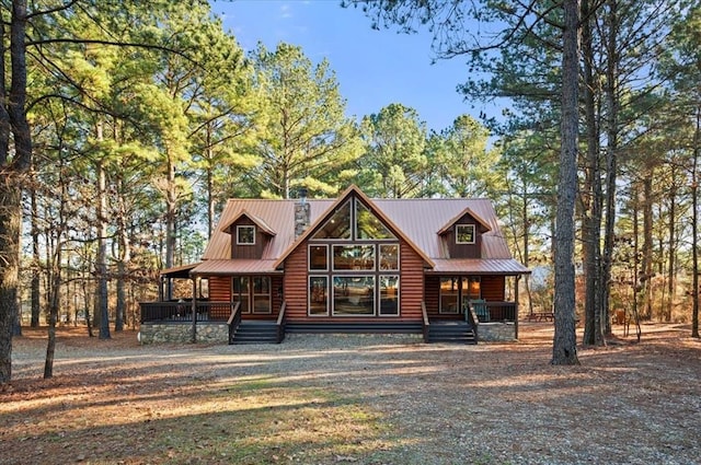 log-style house featuring a porch