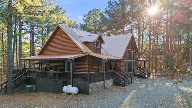 view of front facade with covered porch and central AC unit