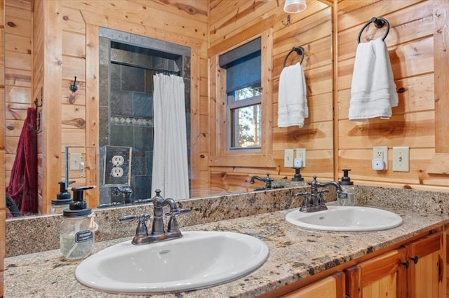 bathroom featuring a shower with shower curtain, vanity, and wooden walls